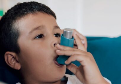 Boy with asthma using inhaler