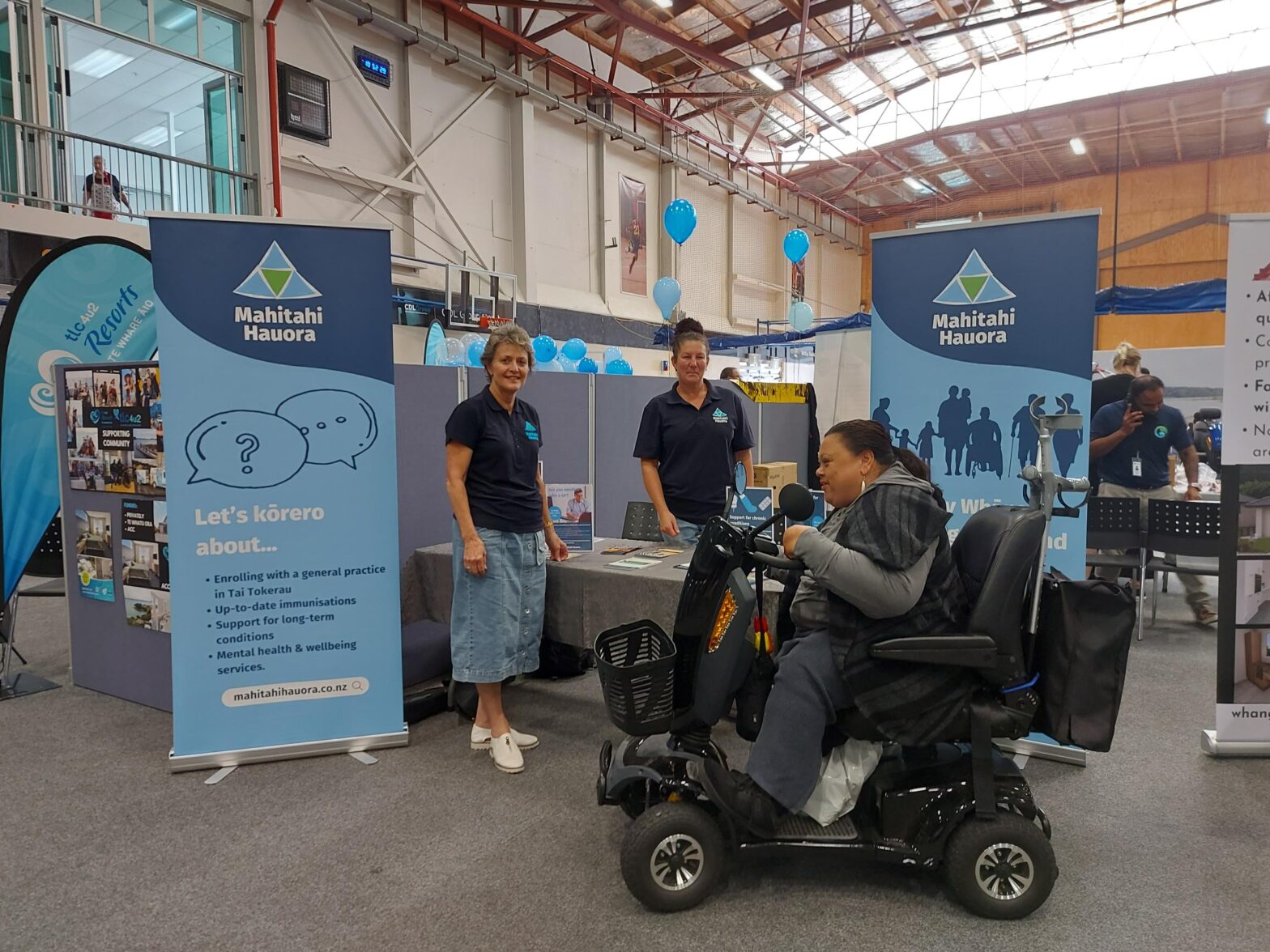 Mahitahi Hauora employees at accessibility expo stand