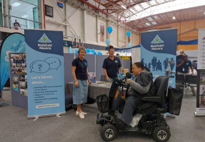 Mahitahi Hauora employees at accessibility expo stand